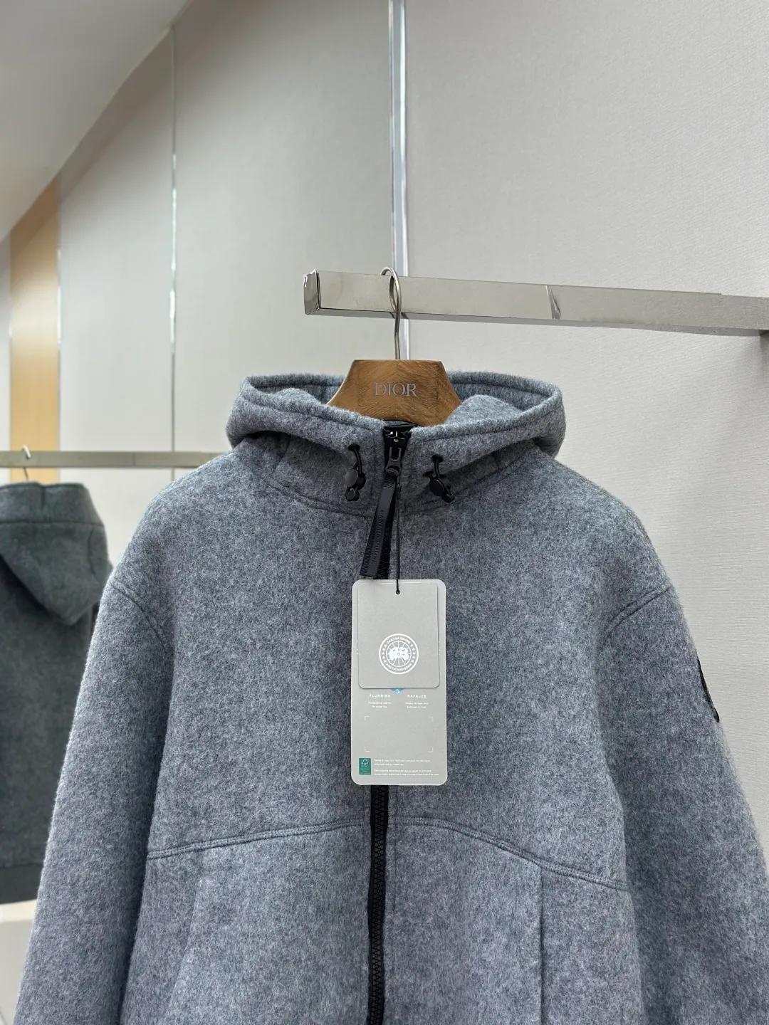 P800 ￼ Canada Goose Fleece Badge Hooded Jacket Fabric selection: Wool fleece fabric blended with wool as the main body and a very small amount of spandex and polyester fiber. Wool is a core natural ingredient that provides unparalleled temperature regulation, antibacterial and anti-odor properties and a skin-friendly feel. The feeding of a small amount of spandex gives the fabric a certain degree of four-way elasticity, making it non-restrictive during daily activities. As the basis of fleece's structure, polyester fiber enhances the fabric's durability, wrinkle resistance and quick-drying properties. It contributes to the loft of the fleece and provides functions such as trapping air.  Detail 1: The sleeves and hem are closed with 2×2 ribbing. Its strong elasticity can closely fit wrists and waists of different thicknesses, forming an effective 'seal' to prevent cold wind from blowing back. It can still maintain its original shape after repeated stretching and use, and is not easy to loose and deform. And the ribbed cuffs can convey a sense of design and enhance the visual beauty.  Detail 2: The combination of hood design and elastic buckle improves warmth and windproof performance when wearing.  Accessories: Customized elastic drawstring buckle Customized zipper pendant Customized armband SIZE: S M L XL
